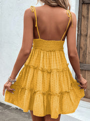 Yellow dotted Swiss tiered tie-strap dress with smocked bodice and ruffled tiers.