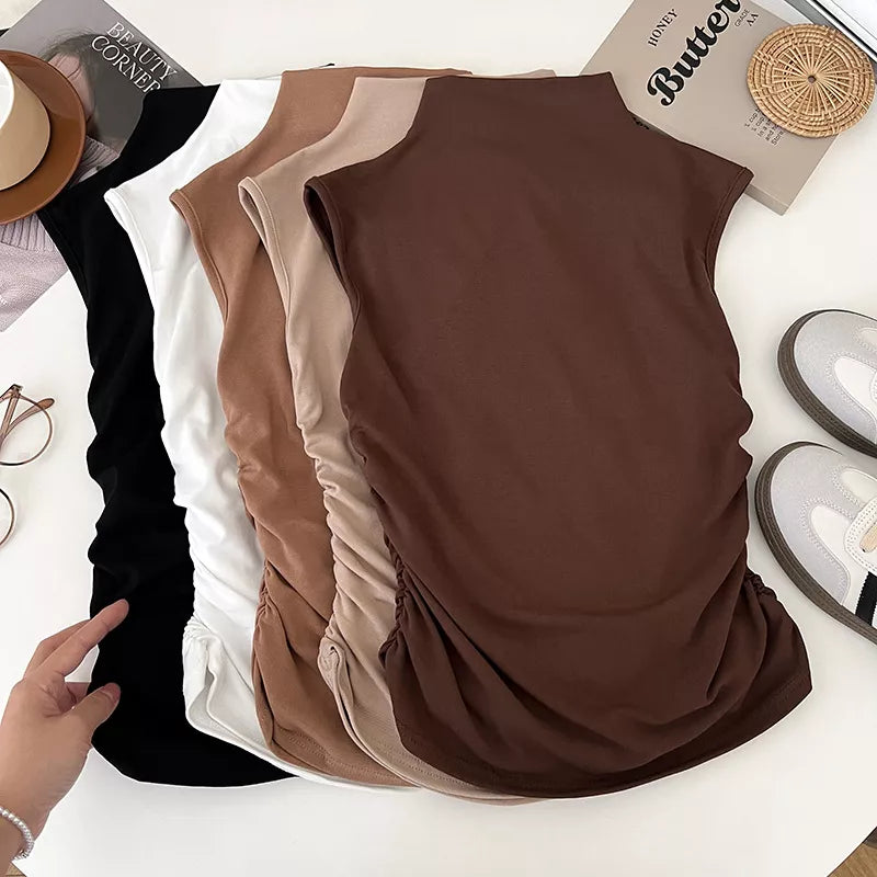 Textured ruching mock neck tank top in brown, black, white, and apricot with draped detail.