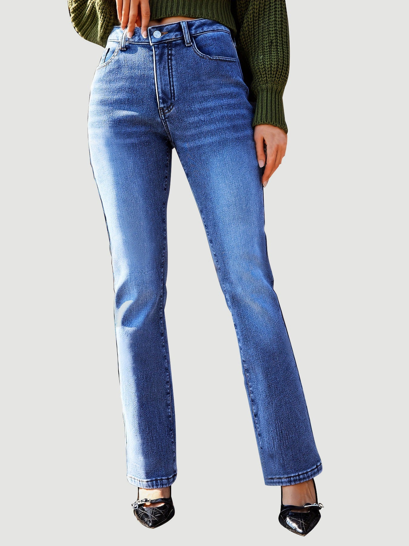 Medium wash denim jeans with a subtle flare and bootcut silhouette.