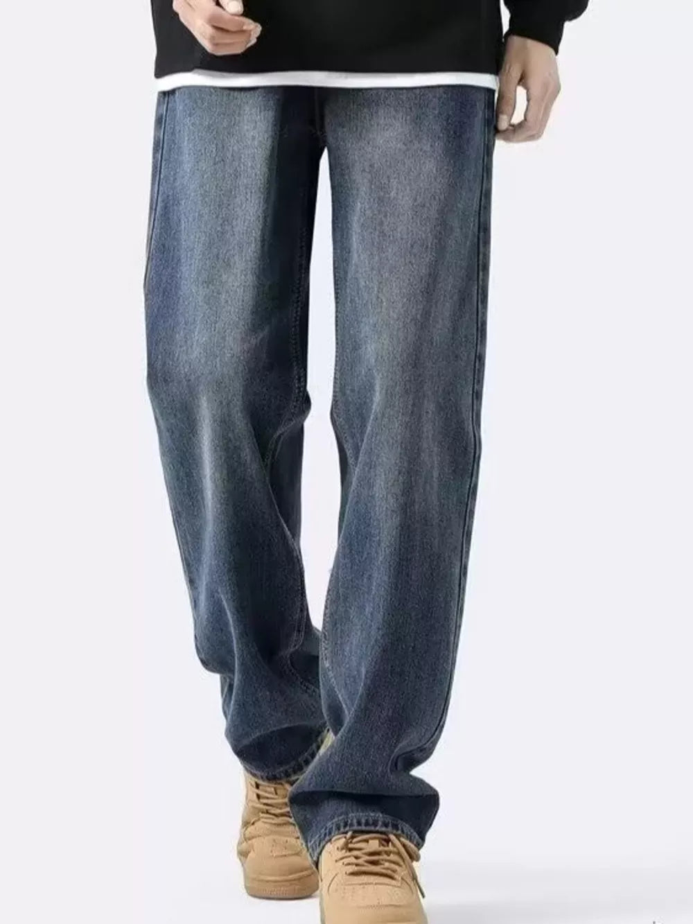 Men's classic vintage loose-fit blue denim jeans with a relaxed cut.