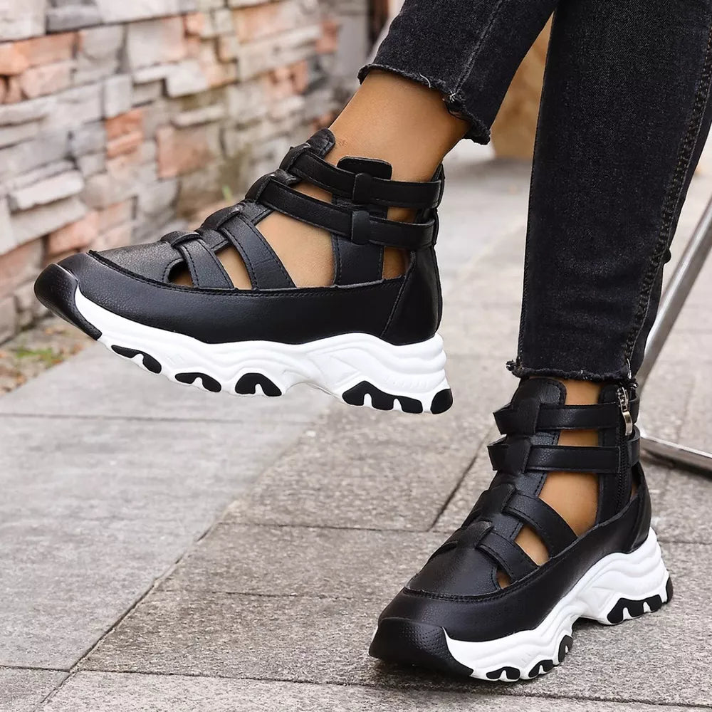 Black chunky cutout platform sneakers with ankle straps and white soles.