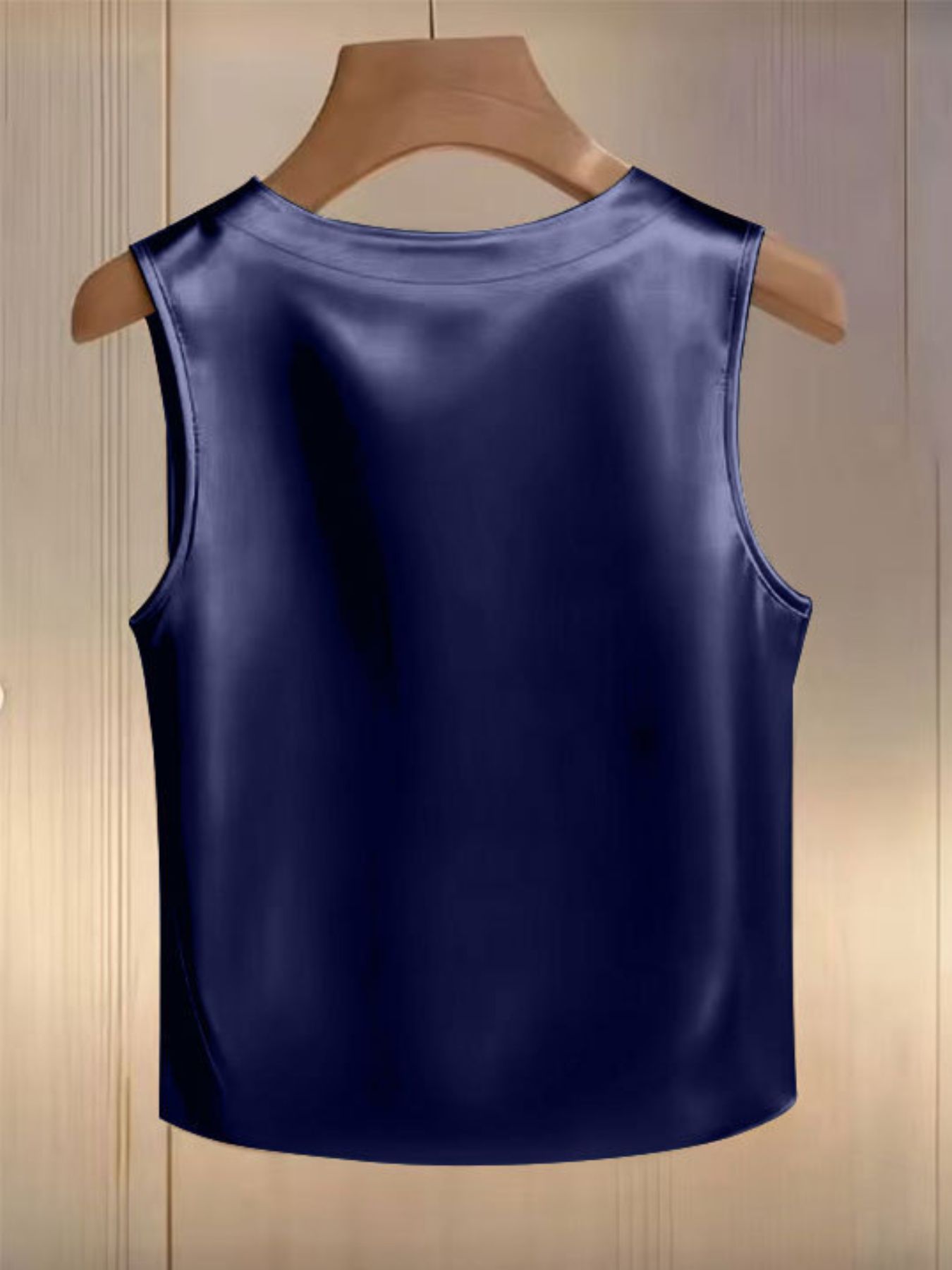 Dark blue satin tank top with pearl embellishments and a round neckline.