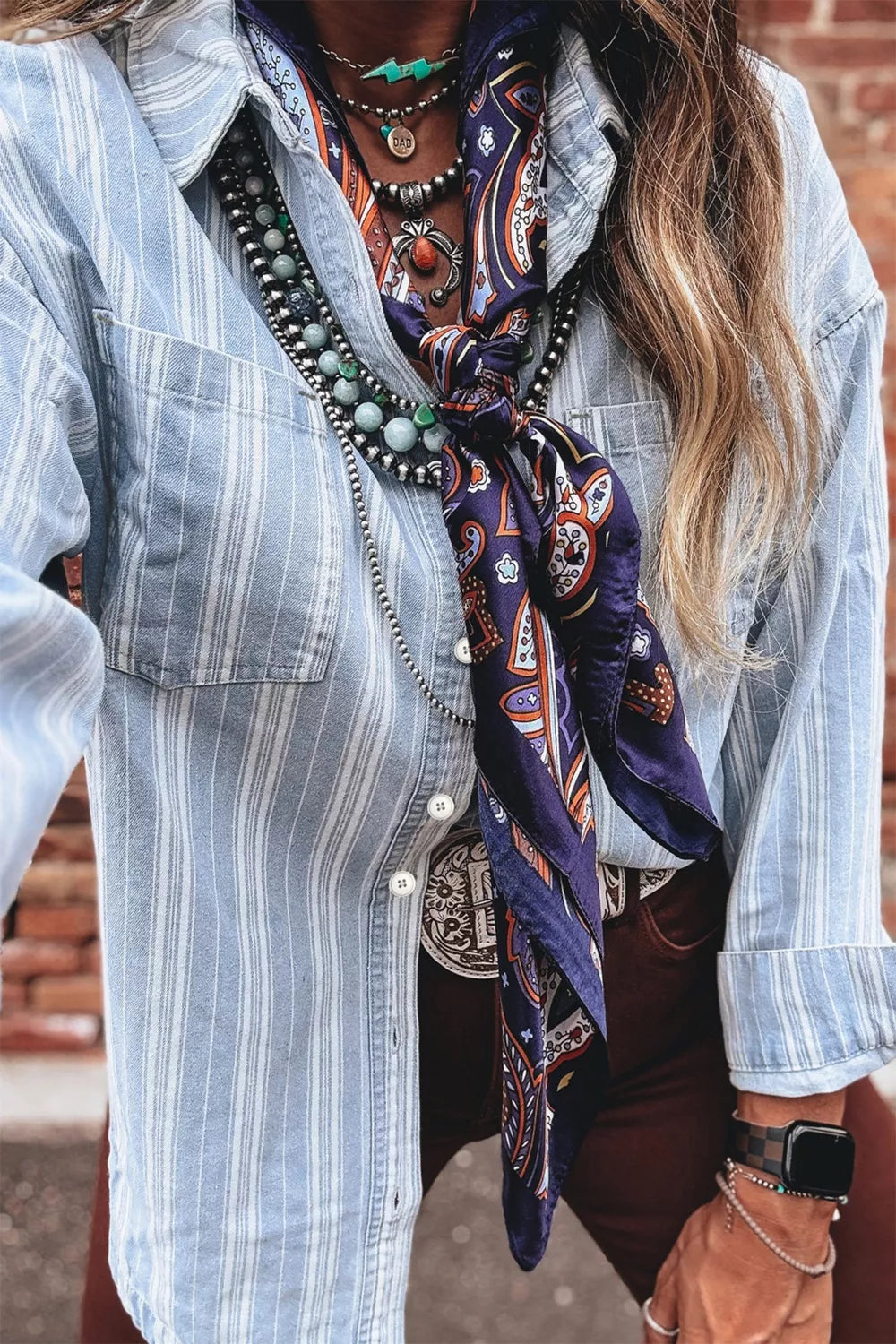 Light blue striped denim shacket with button-down front and chest pockets.