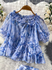 Blue floral ruffle bikini top with bow detail and tie straps.