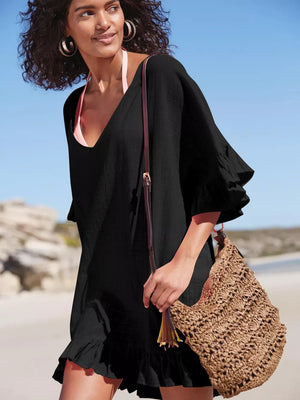 Black ruffled V-neck beach cover-up with flutter sleeves and hem detail.