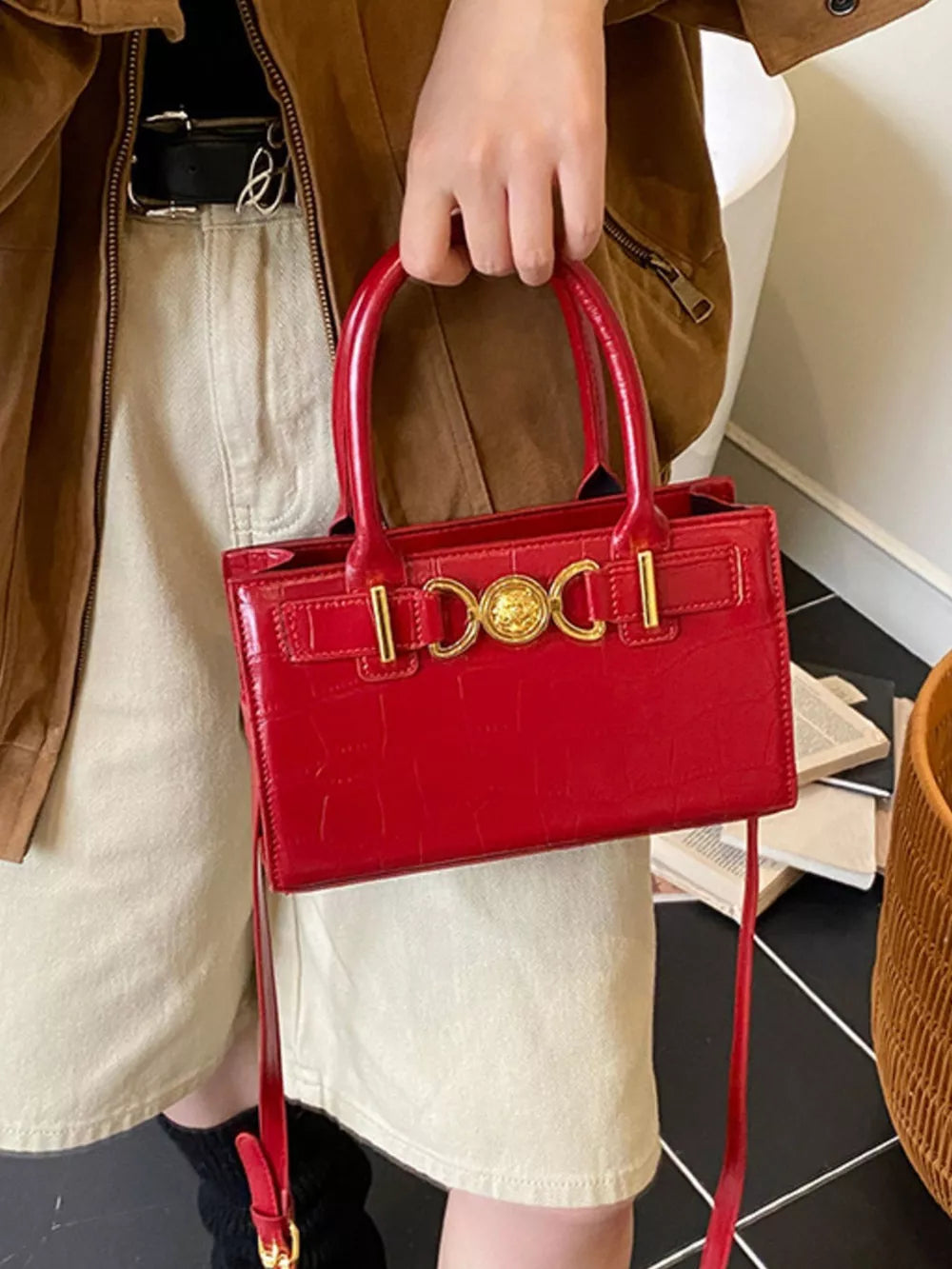 Red crocodile-textured crossbody bag with gold hardware detail