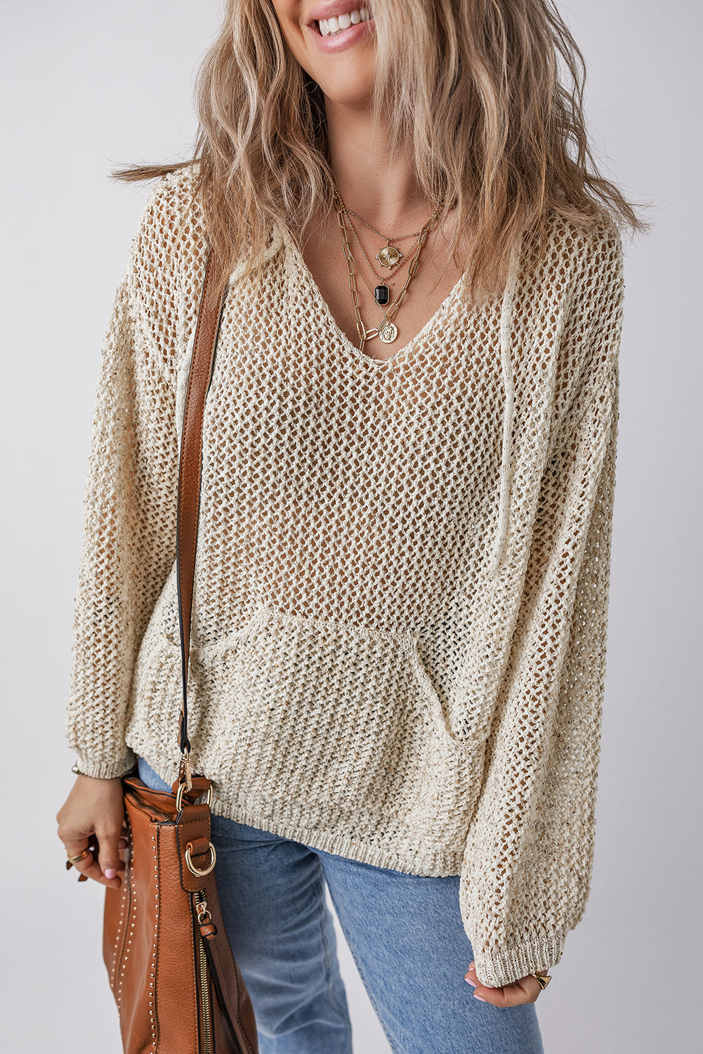 Beige open-knit V-neck hoodie pullover with drawstring and front pocket.