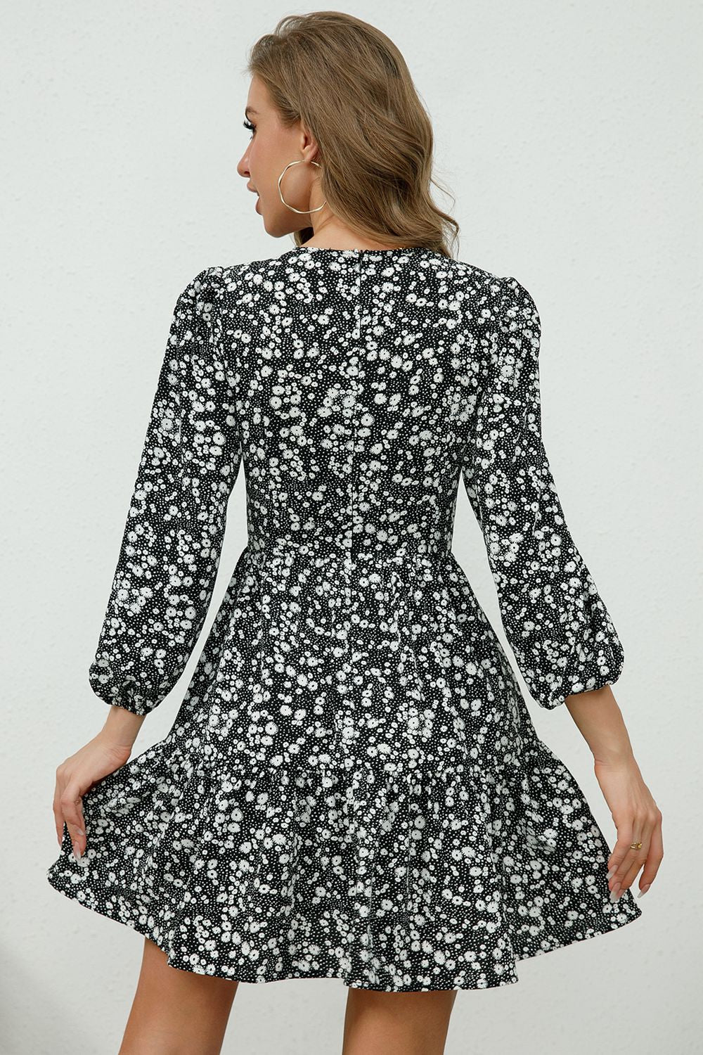 Black floral print mini dress with lace trim and puff sleeves.
