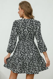 Black floral print mini dress with lace trim and puff sleeves.