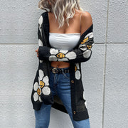 Black intarsia knit cardigan with daisy smile pattern, button front, and long sleeves.