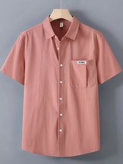 Coral short-sleeve button-up shirt with chest pocket and white buttons.