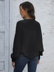 Black acrylic batwing sleeve cardigan with ribbed texture and balloon sleeves.