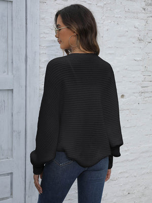 Black acrylic batwing sleeve cardigan with ribbed texture and balloon sleeves.