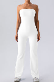 White ribbed bandeau flare leg jumpsuit with a seamless bodice and athletic shoes.