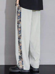 Men's light gray sweatpants with a printed side stripe featuring cartoon bears.