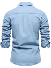 Light blue faded denim utility shirt with button cuffs and a classic collar.