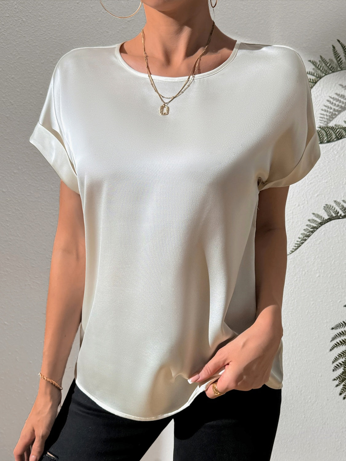 Light gray satin blouse with cuffed short sleeves and a relaxed fit.