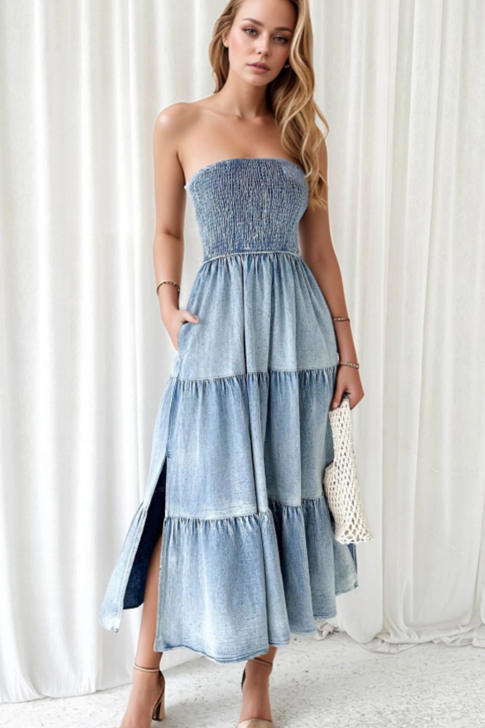 Light blue denim strapless tiered maxi dress with smocked bodice and side slits.