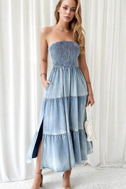 Light blue denim strapless tiered maxi dress with smocked bodice and side slits.