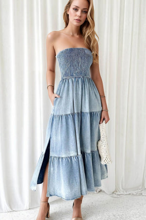 Light blue denim strapless tiered maxi dress with smocked bodice and side slits.