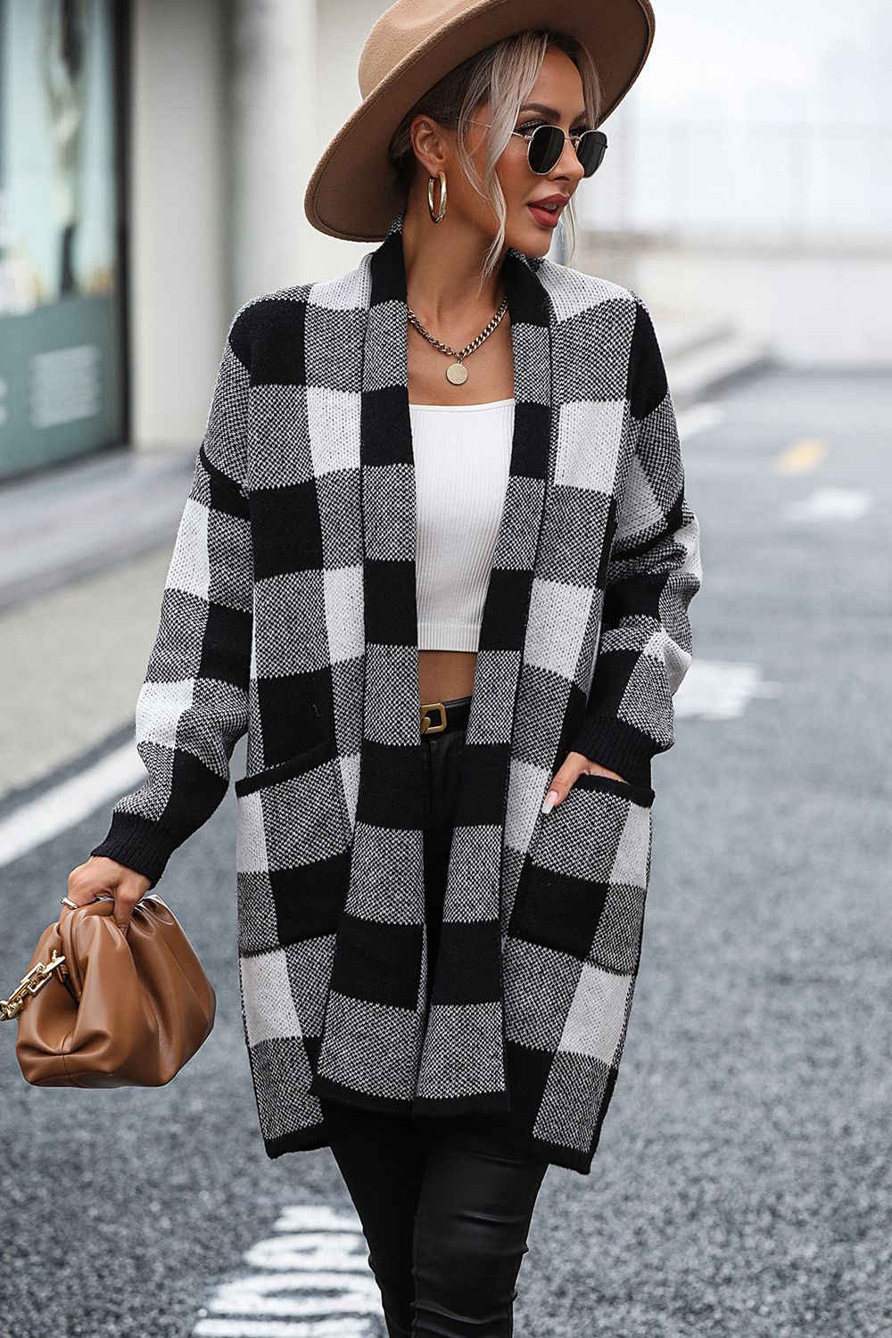 Black and white checkerboard knit duster coat with pockets and open front.