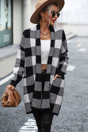 Black and white checkerboard knit duster coat with pockets and open front.