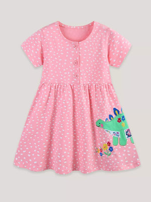 Baby pink polka dot cotton dress with dinosaur appliqué and floral detail.