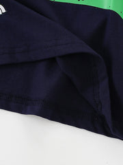 Children's navy t-shirt with a green dinosaur graphic detail and visible stitching.