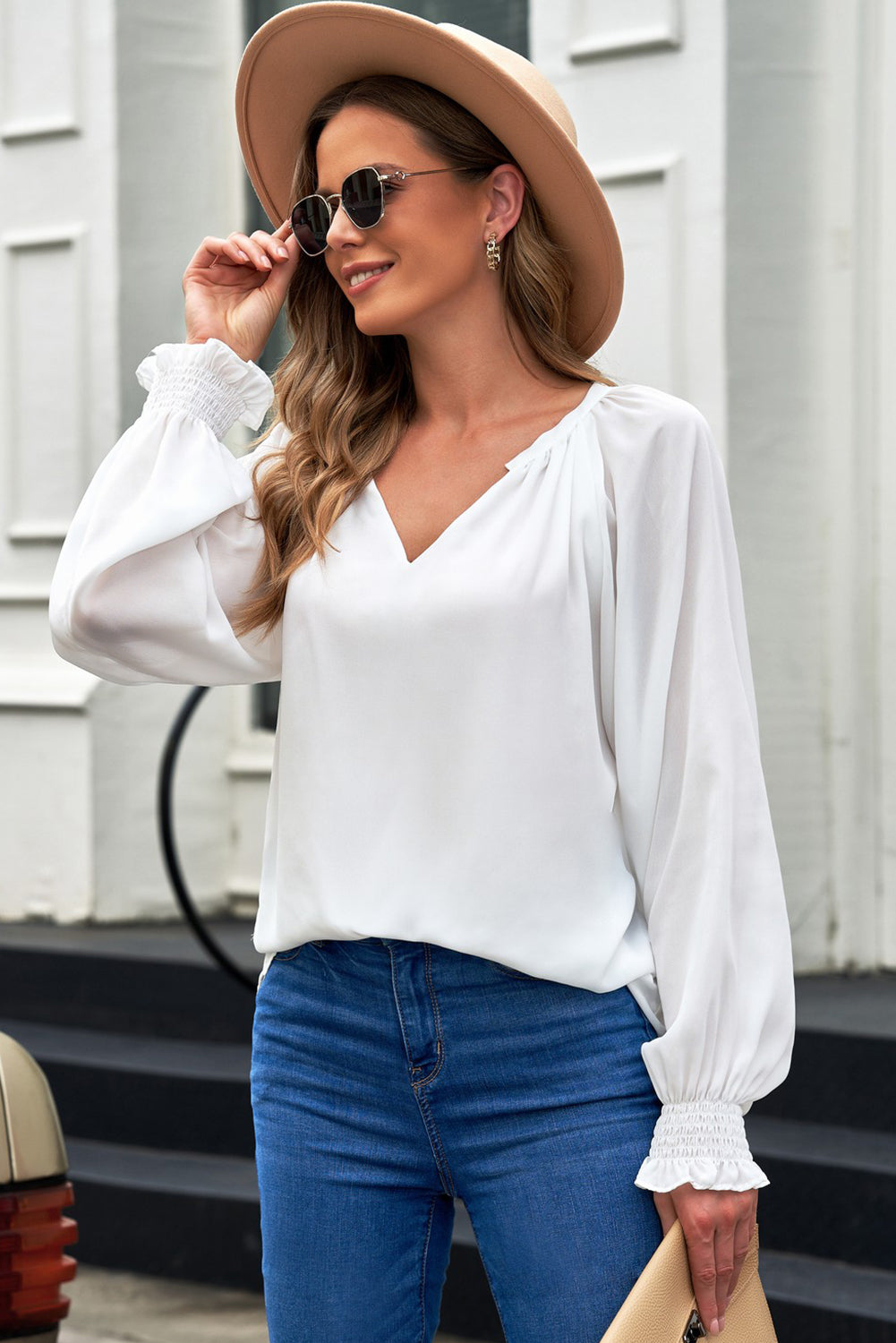 White ruched cuff voluminous sleeve blouse with V-neckline.