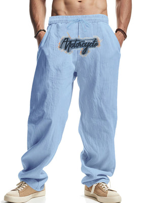 Light blue drawstring sweatpants with motorcycle graphic detail on the left thigh.