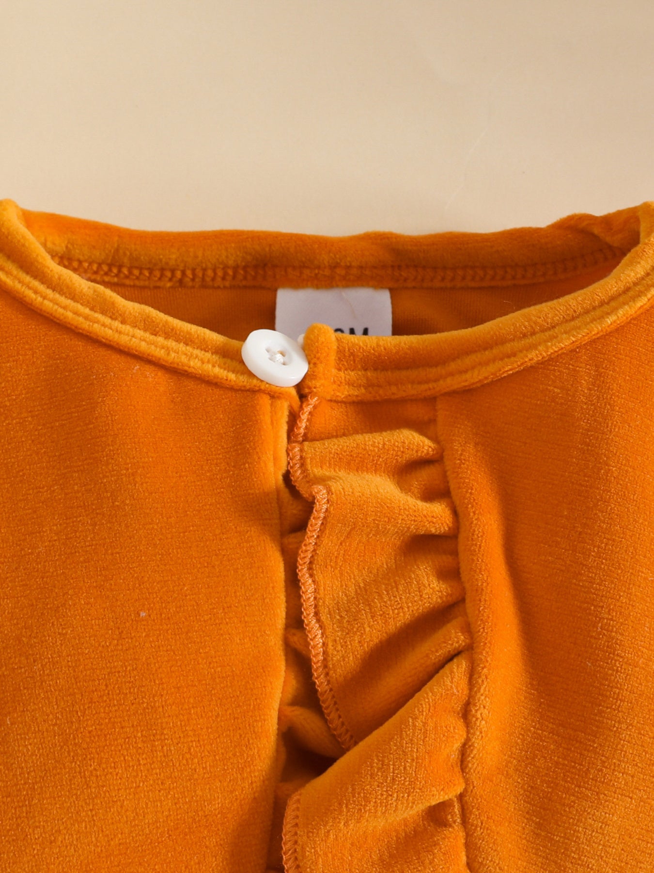 Orange baby set with ruffled cardigan and bow detail
