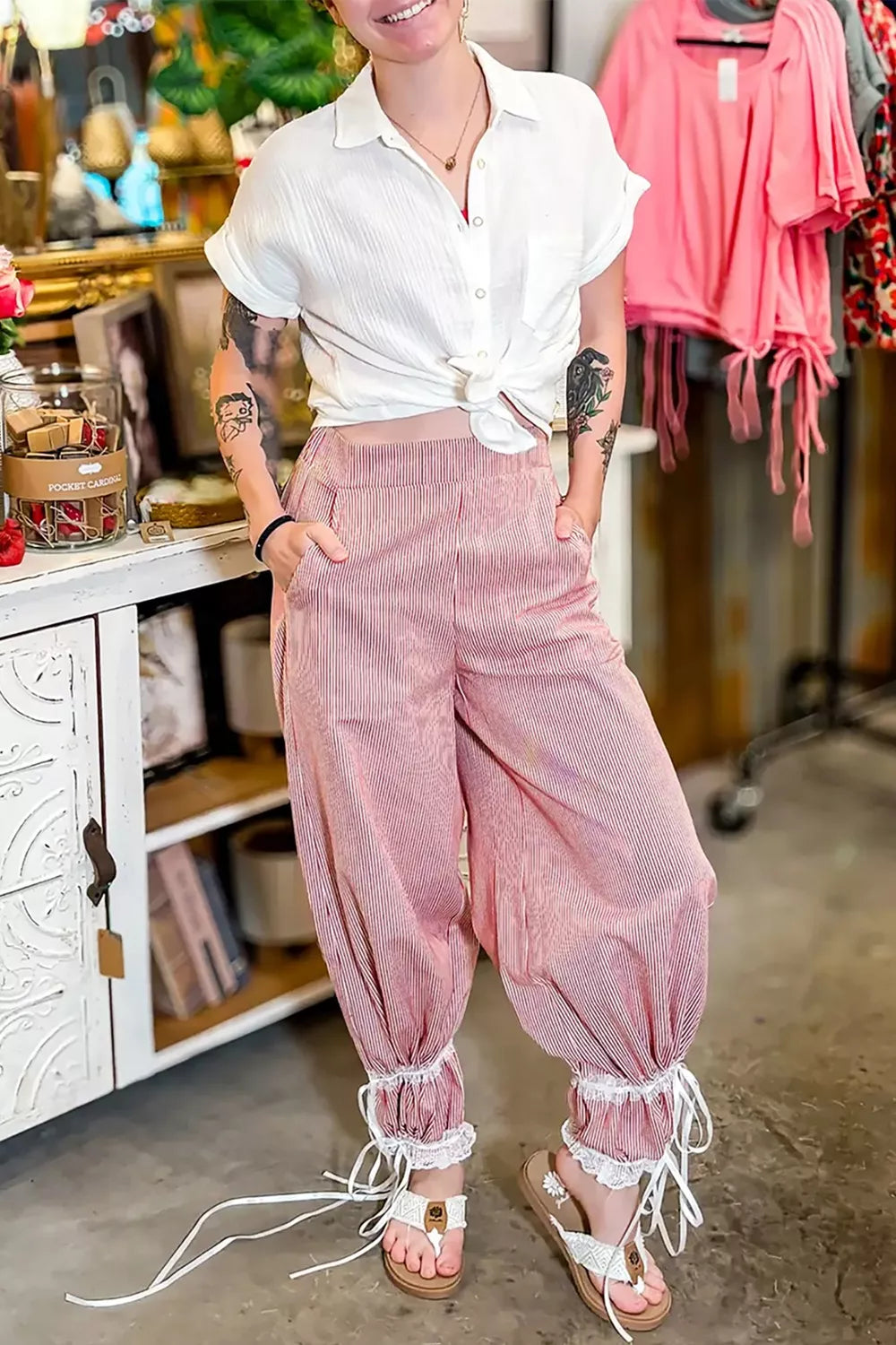 Lace-trimmed stripe wide-leg maternity pants with drawstring ankles in pink and white.
