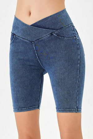 Denim bermuda shorts in medium blue with a crisscross waistband and a close fit.