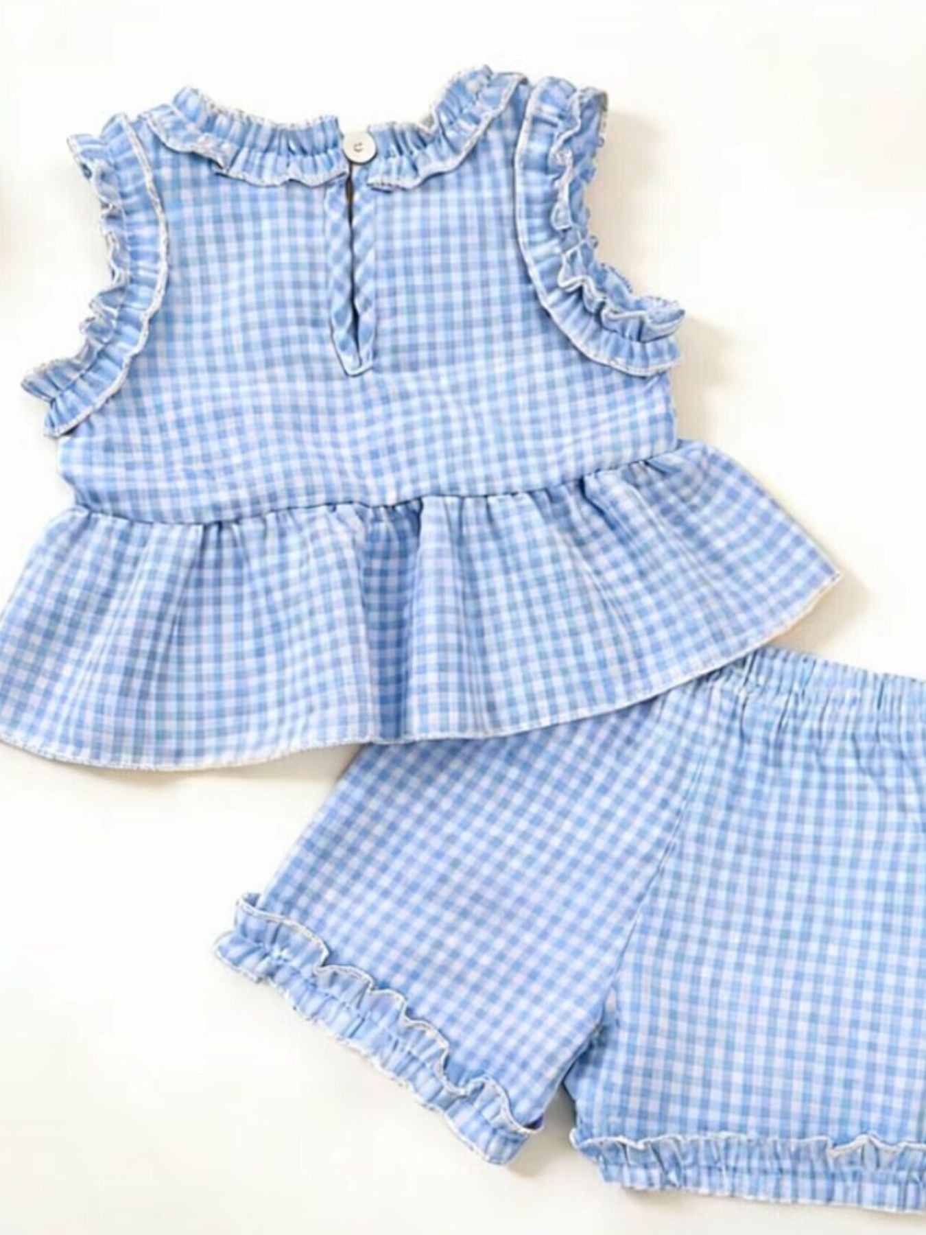 Children's light blue gingham ruffle two-piece set with peplum top and shorts.