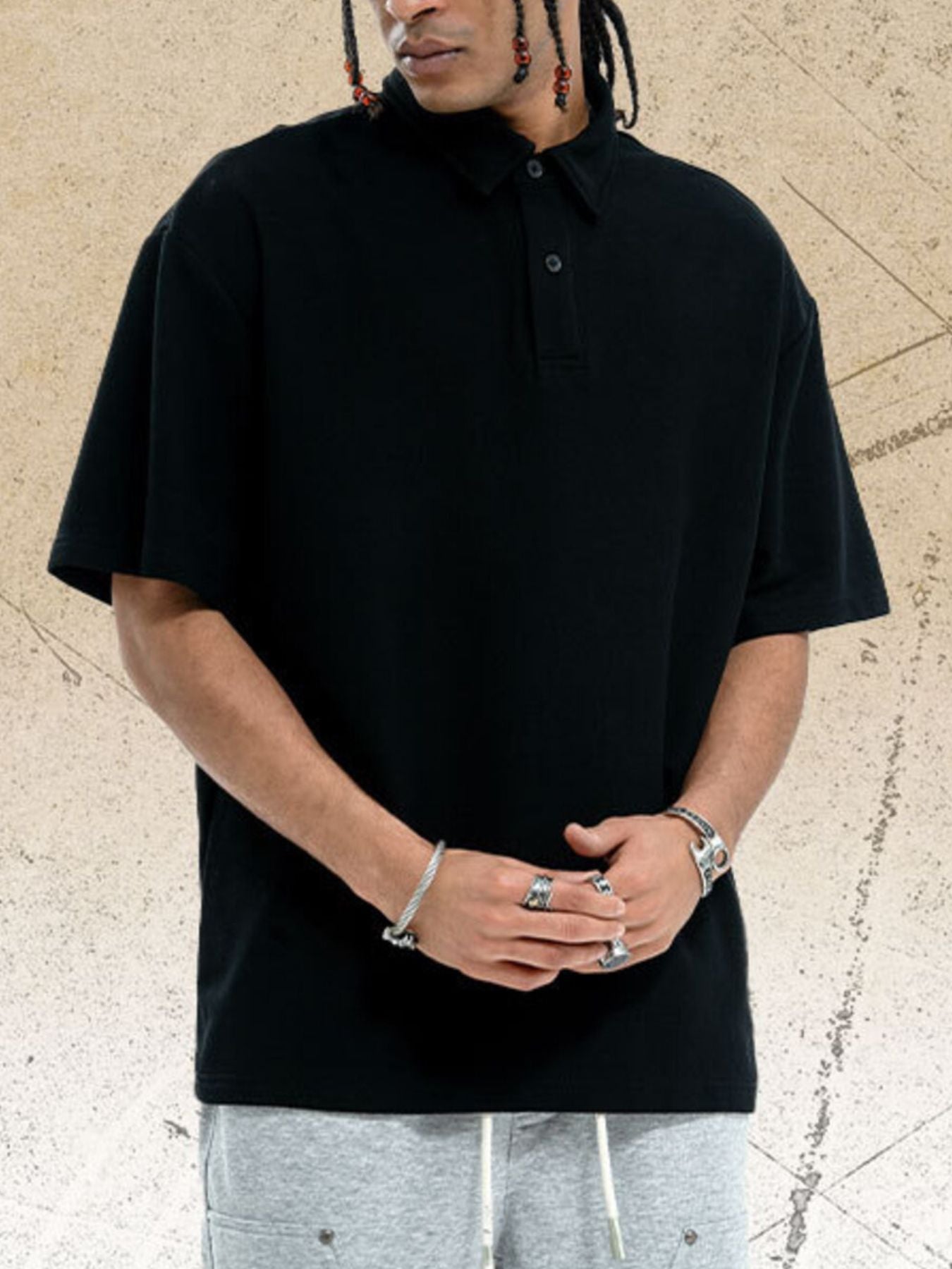 Black cotton polo shirt with buttoned collar and short sleeves