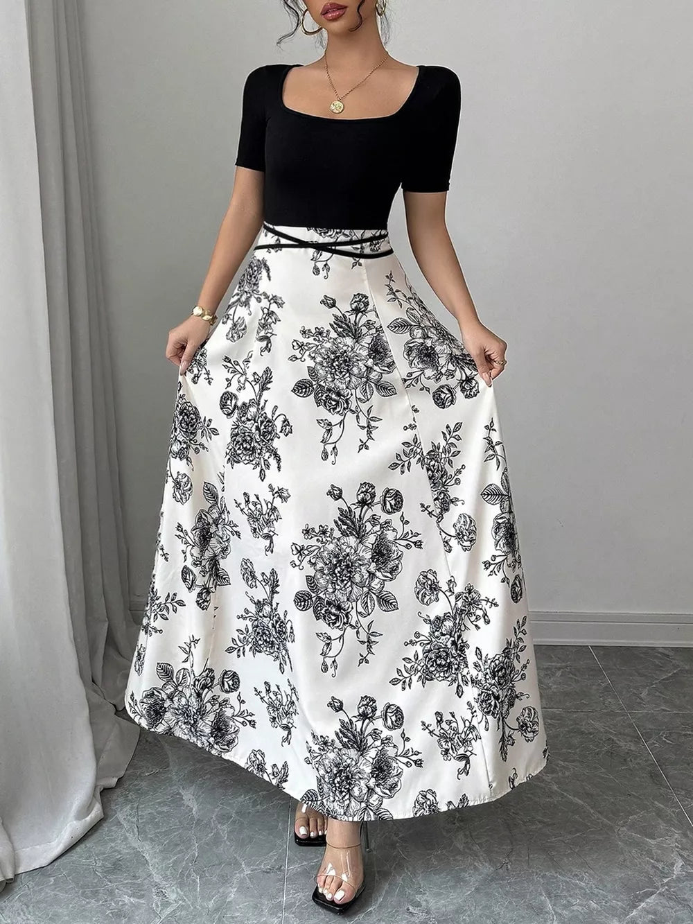 Maxi dress with black top, white floral skirt, square neckline, and short sleeves.