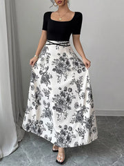 Maxi dress with black top, white floral skirt, square neckline, and short sleeves.