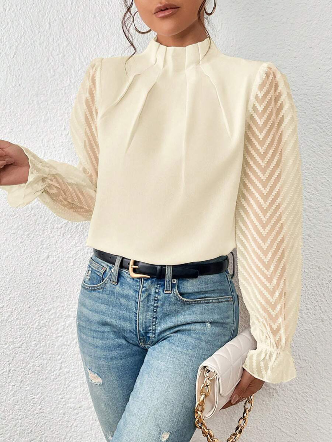 Cream ruffle neck blouse with sheer chevron sleeves and ruffled cuffs.