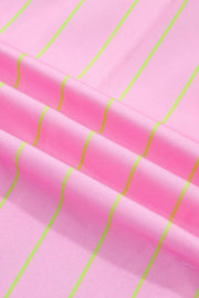 Pink polo shirt with neon green vertical stripes, fabric detail
