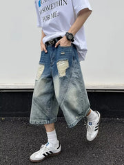 Men's distressed wide-leg denim shorts in light wash blue with ripped details.
