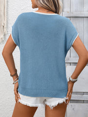 Blue ribbed knit short-sleeve sweater top with white trim, worn with white shorts.