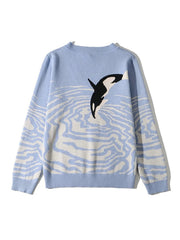 Light blue acrylic blend V-neck sweater with an orca jumping through water pattern.