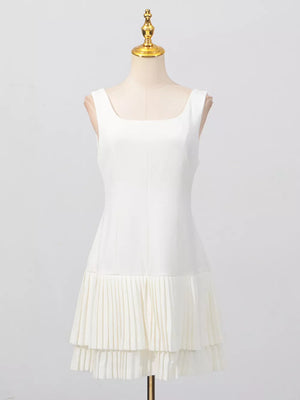 White square neck sleeveless mini dress with layered pleated hem detail.