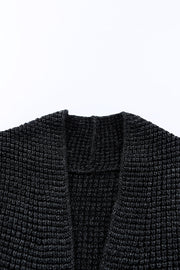 Textured acrylic open cardigan in black with a waffle knit pattern.