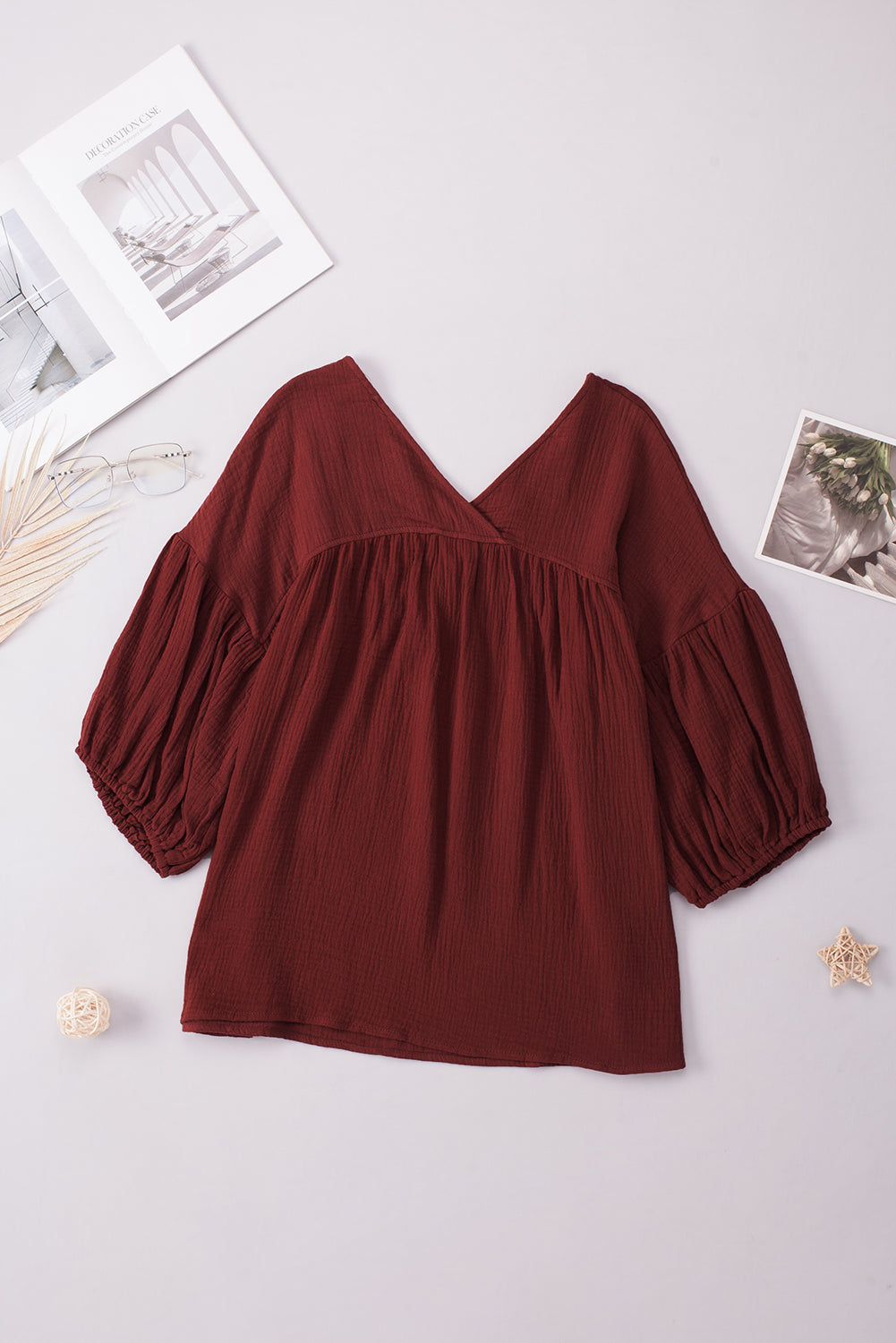 Textured gauze blouse in burnt coral with V-neck and gathered balloon sleeves.