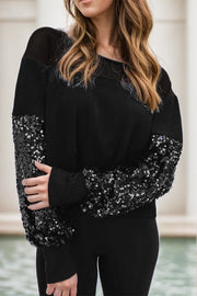 Black ribbed knit sweater with sequin sleeves and boat neck