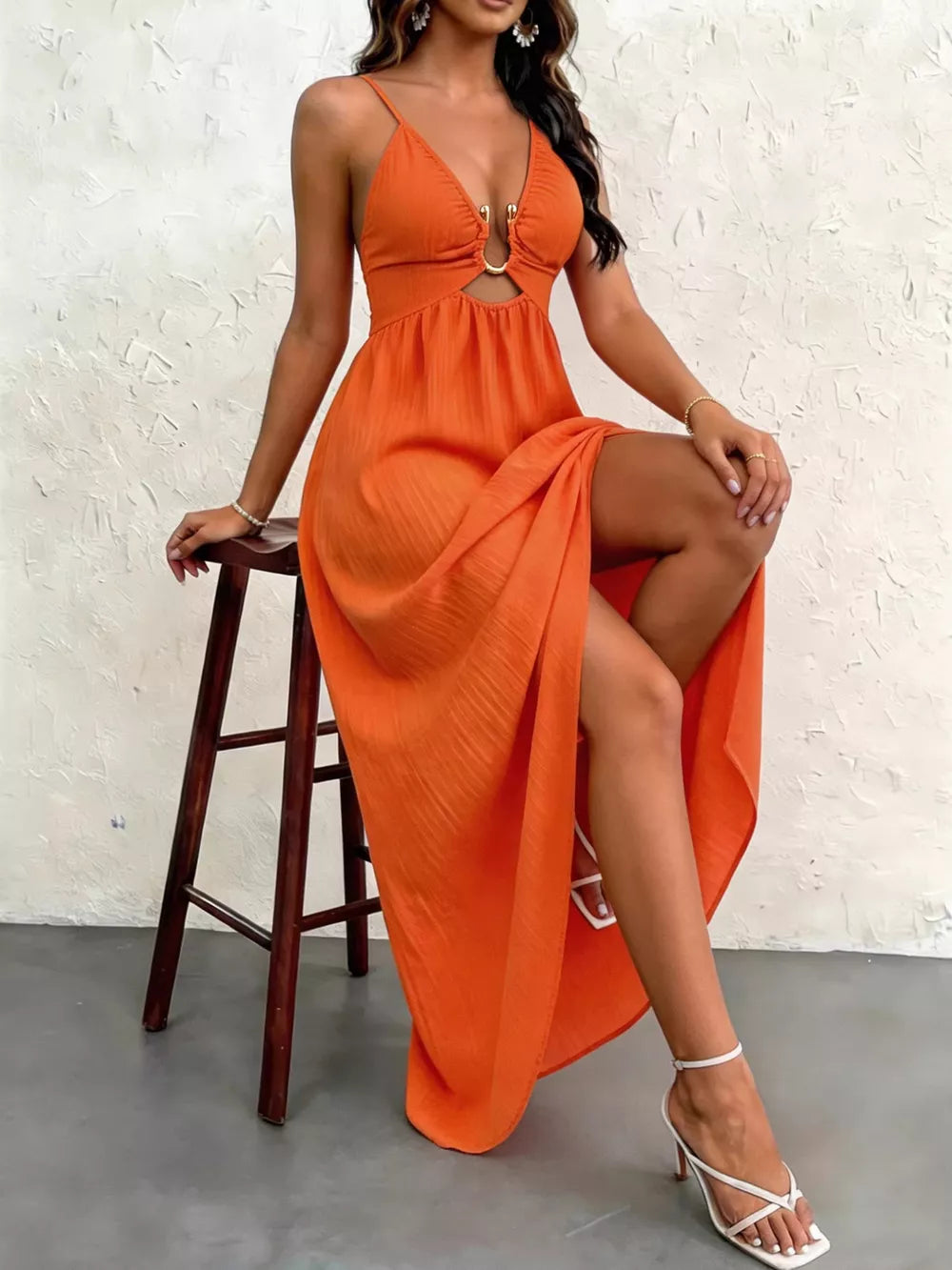 Orange maxi dress with cutout, O-ring detail, spaghetti straps, and high slit.