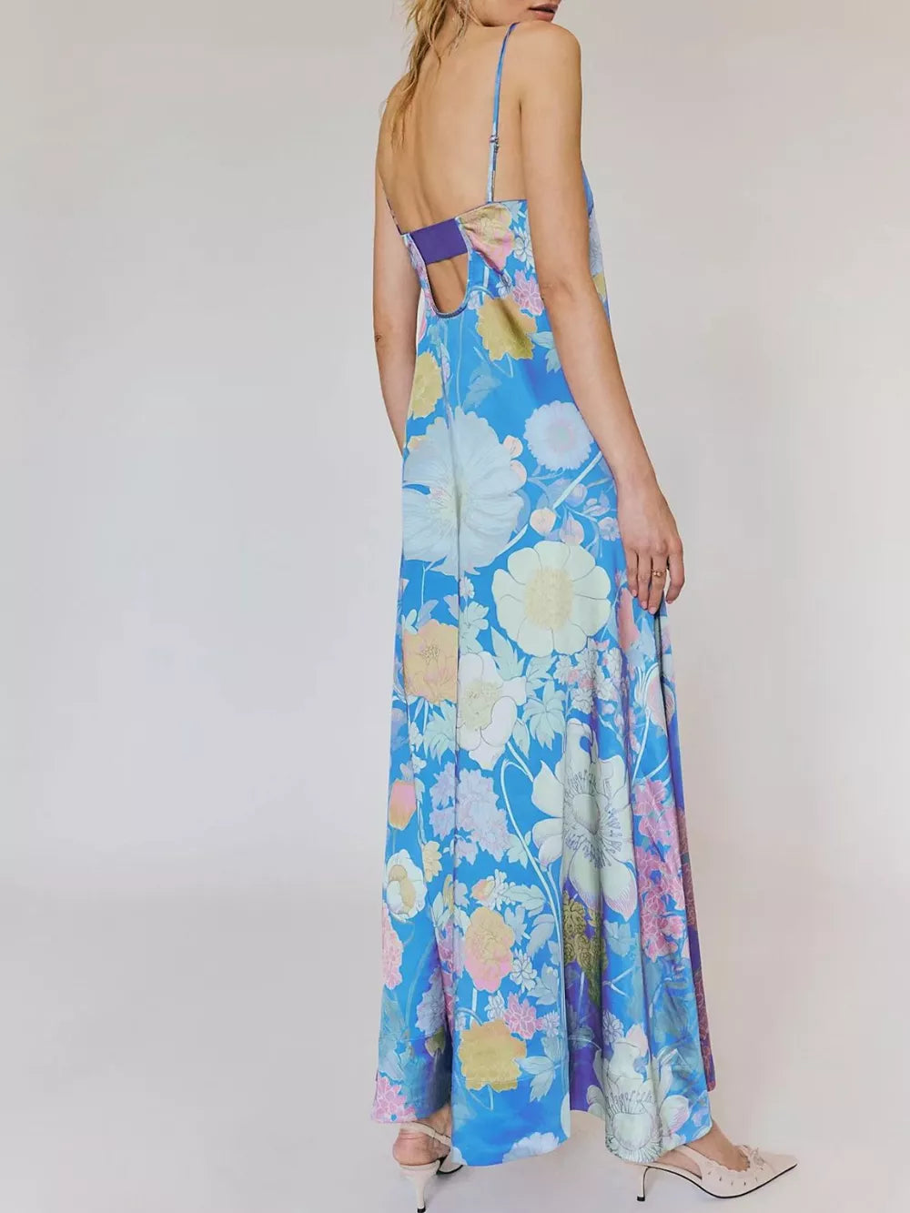 Maxi dress in sky blue with vibrant floral print, gathered bodice detail, and open back.