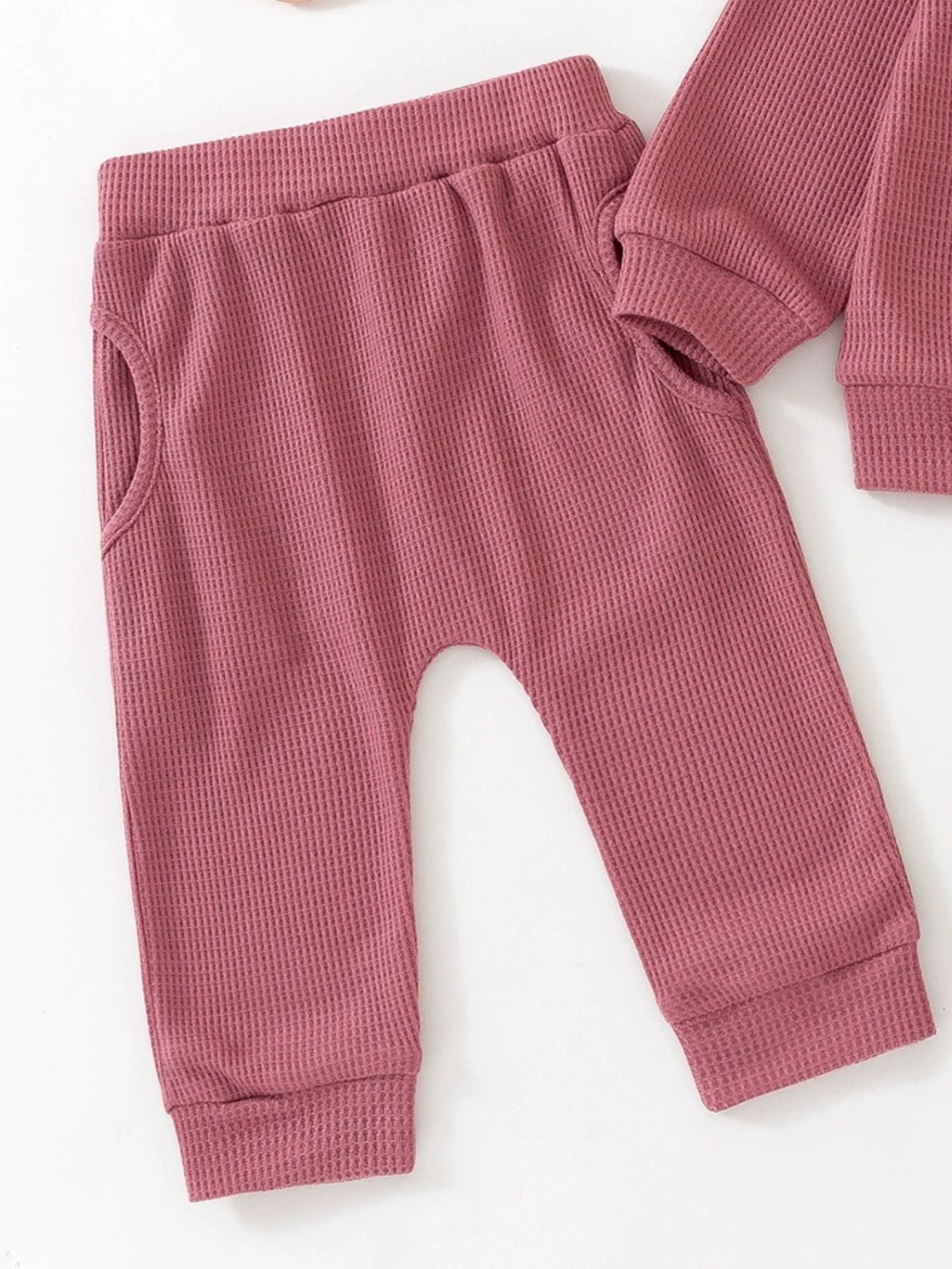 Toddler dusty rose waffle knit pants with elastic waist and pockets.
