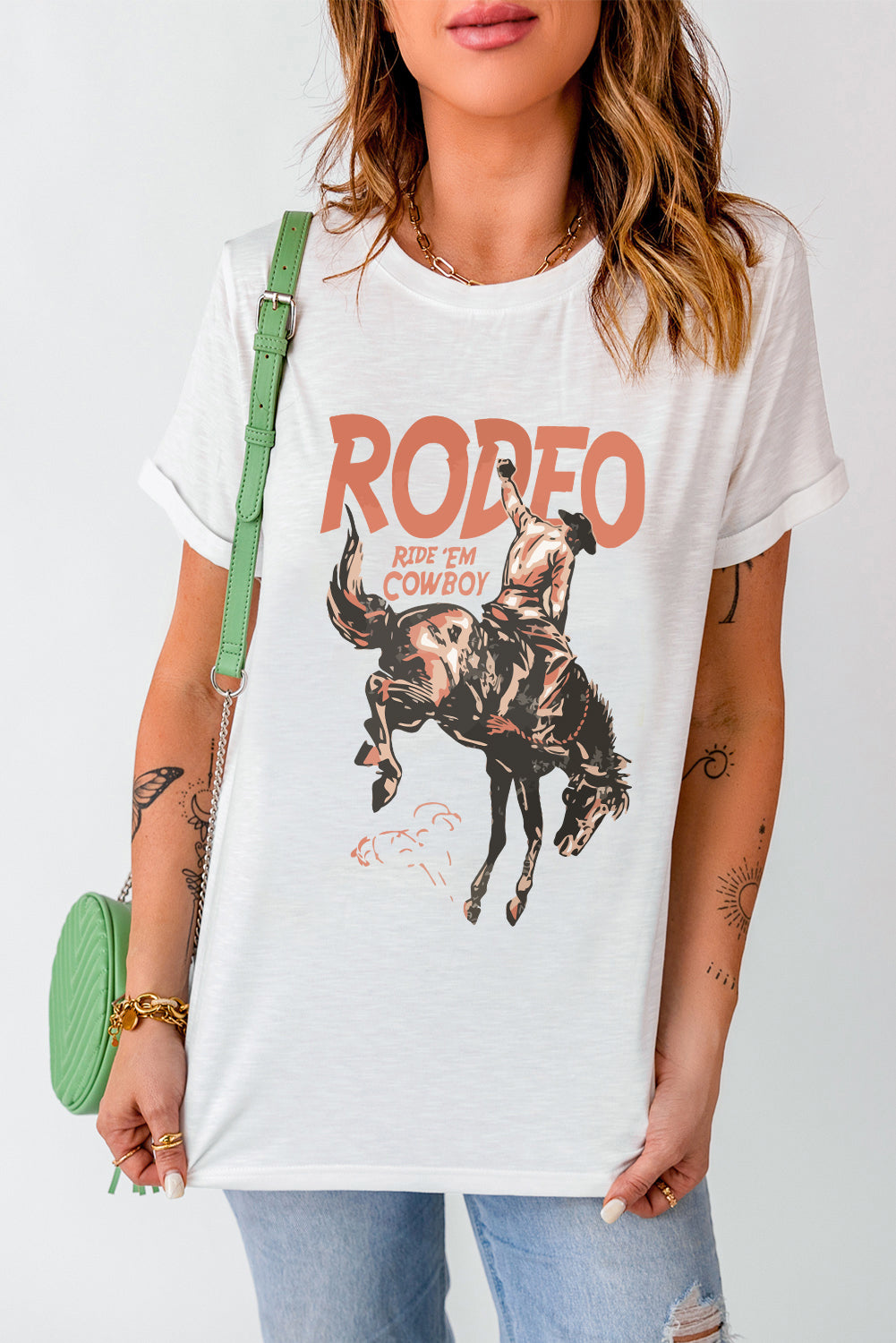 White graphic tee with rodeo cowboy riding a bucking bronco and distressed text.